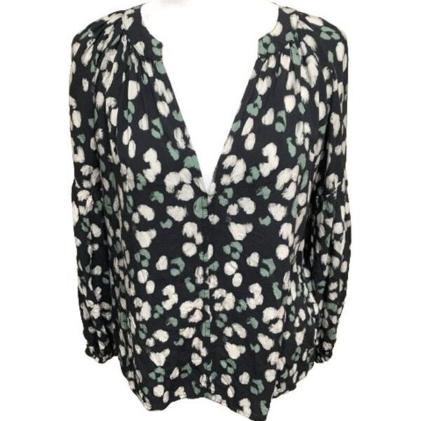 A black long-sleeve blouse with a white and green abstract print, featuring a V-neckline and gathered shoulders.