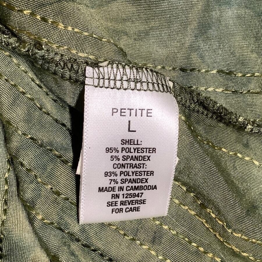 A clothing tag on a green fabric indicates size "Petite L" and materials including polyester and spandex. Made in Cambodia, with care instructions.