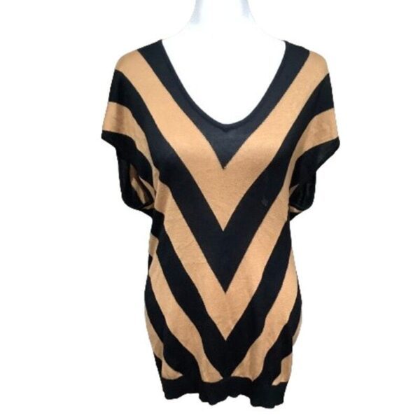 A V-shaped chevron striped top with a color pattern of black and tan, displayed on a white mannequin.