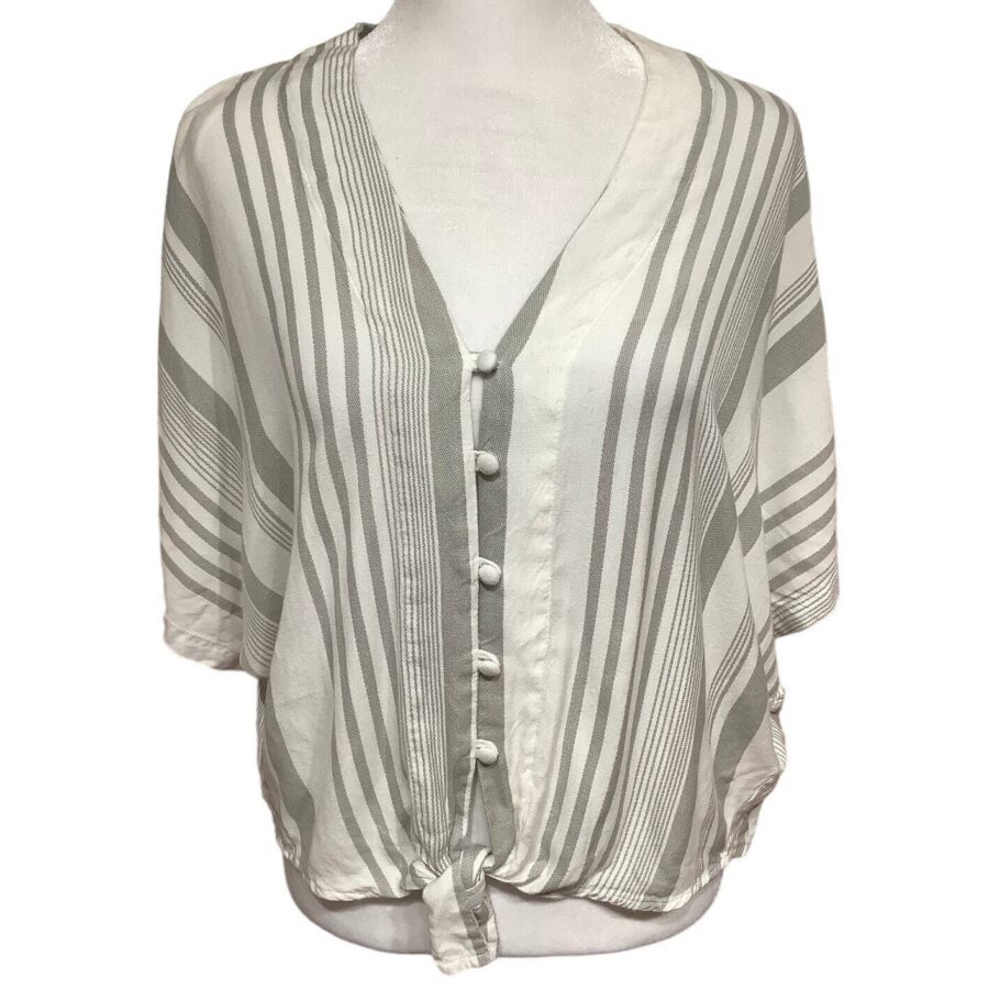 A person is wearing a white and gray striped blouse with a front button-down design and a tie at the bottom.