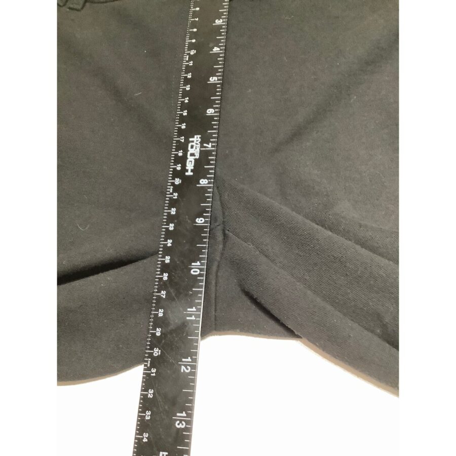 A close-up image of a black fabric with a labeled, transparent ruler placed on top, measuring a section marked at 10 inches.