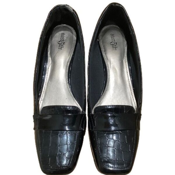 A pair of black, leather loafers with a crocodile pattern and a label reading "easy spirit" inside, displayed top view on a white background.