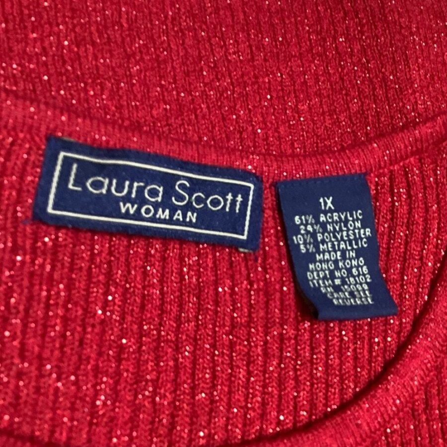 Red fabric with "Laura Scott" label. The tag indicates material composition and size as "1X." The garment is made in Hong Kong.