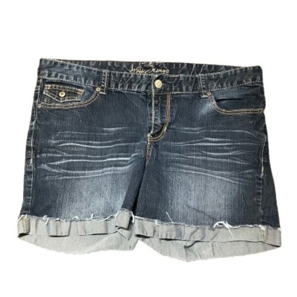 Denim shorts with frayed hems and subtle whiskering details. The waistband features a button and zipper closure, with five pockets for convenience.