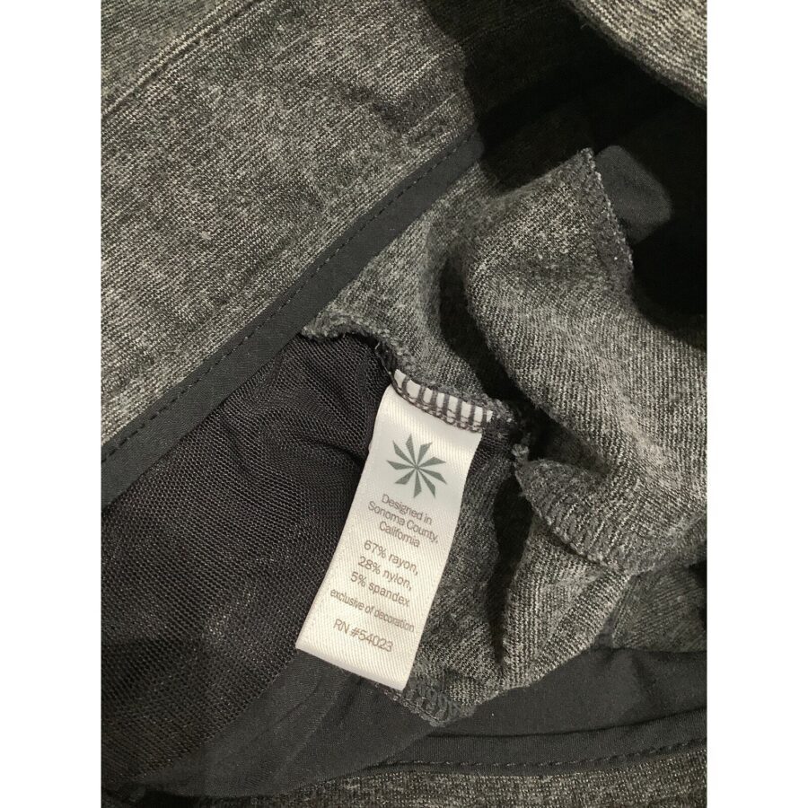 Close-up of a clothing tag inside a dark gray garment, indicating fabric composition as 67% rayon, 28% nylon, and 5% spandex.