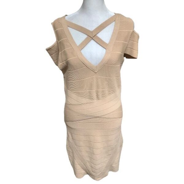 A beige bodycon dress with short sleeves and a V-neck featuring cross straps is displayed on a mannequin against a plain backdrop.