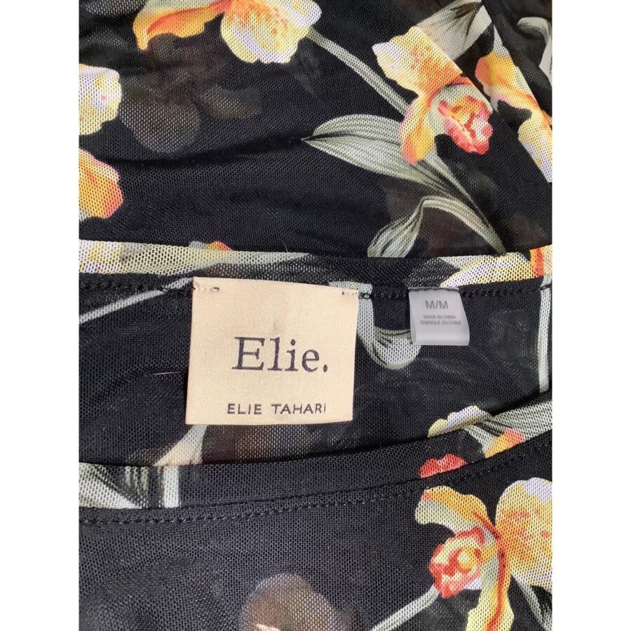 Floral-patterned fabric with yellow and orange flowers. Label reads "Elie Tahari." No recognizable landmarks or historical buildings are visible in this image.