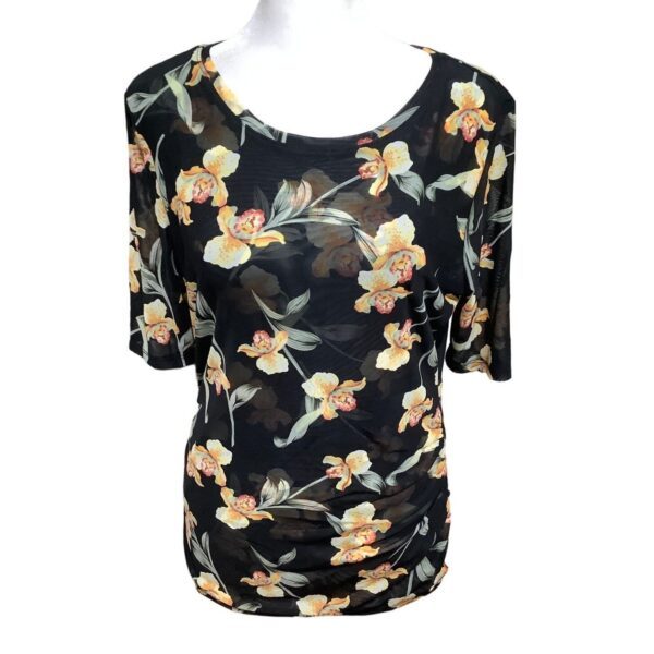 A floral-patterned black short-sleeve blouse is displayed on a white mannequin. The blouse features a delicate yellow and orange flower design.