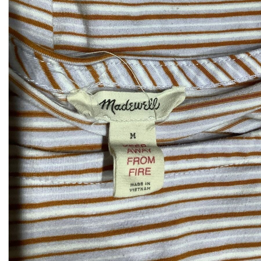 A close-up of a Madewell brand tag on a striped garment, with care instructions and "Made in Vietnam" text visible.