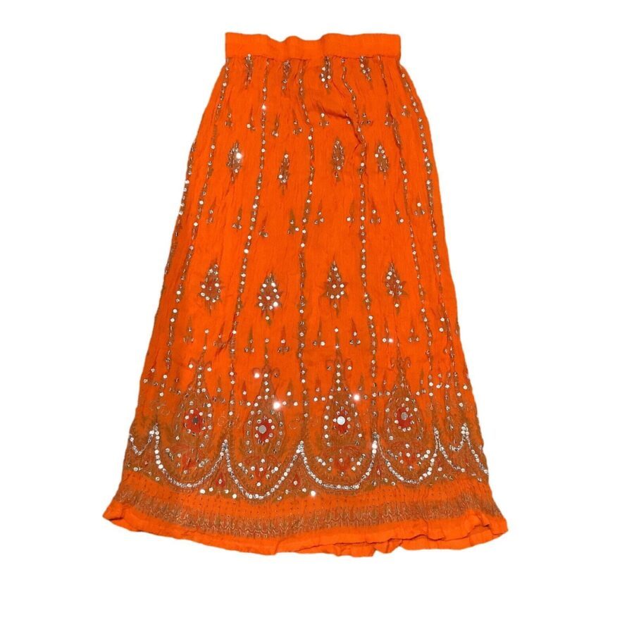 An ornate orange skirt decorated with intricate beadwork and patterns, featuring a shimmering design that exudes traditional craftsmanship and cultural artistry.