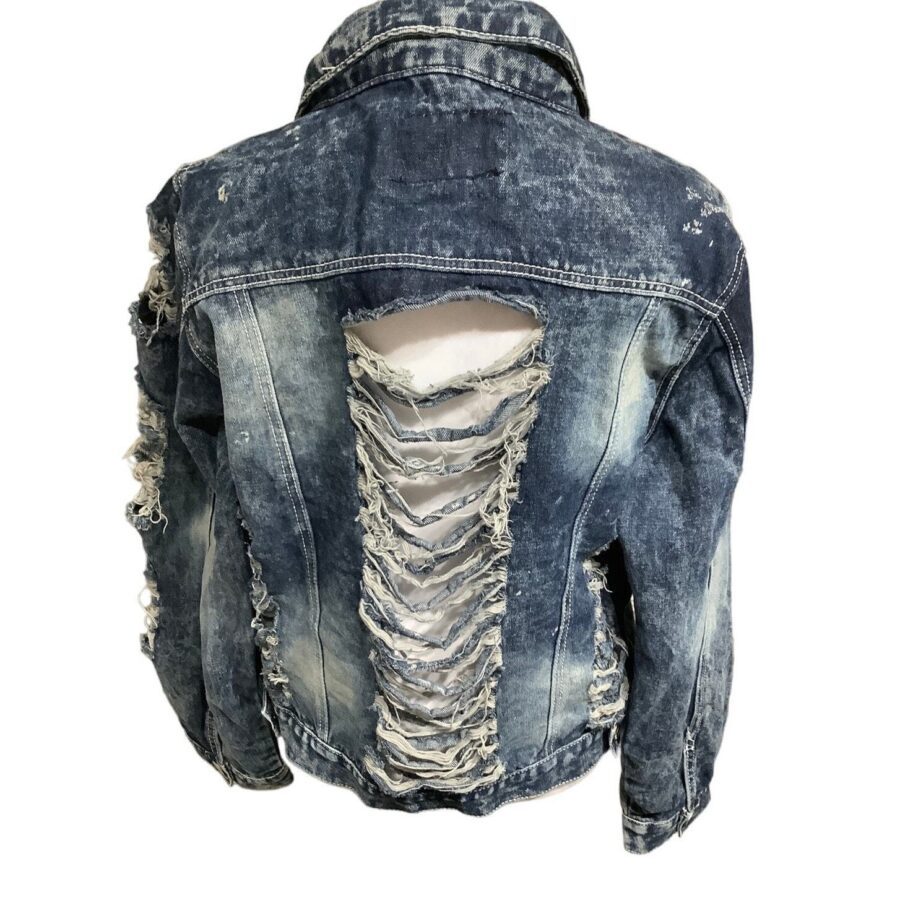 A distressed denim jacket with extensive frayed and ripped detailing on the back, revealing a white inner fabric layer. No people or landmarks present.