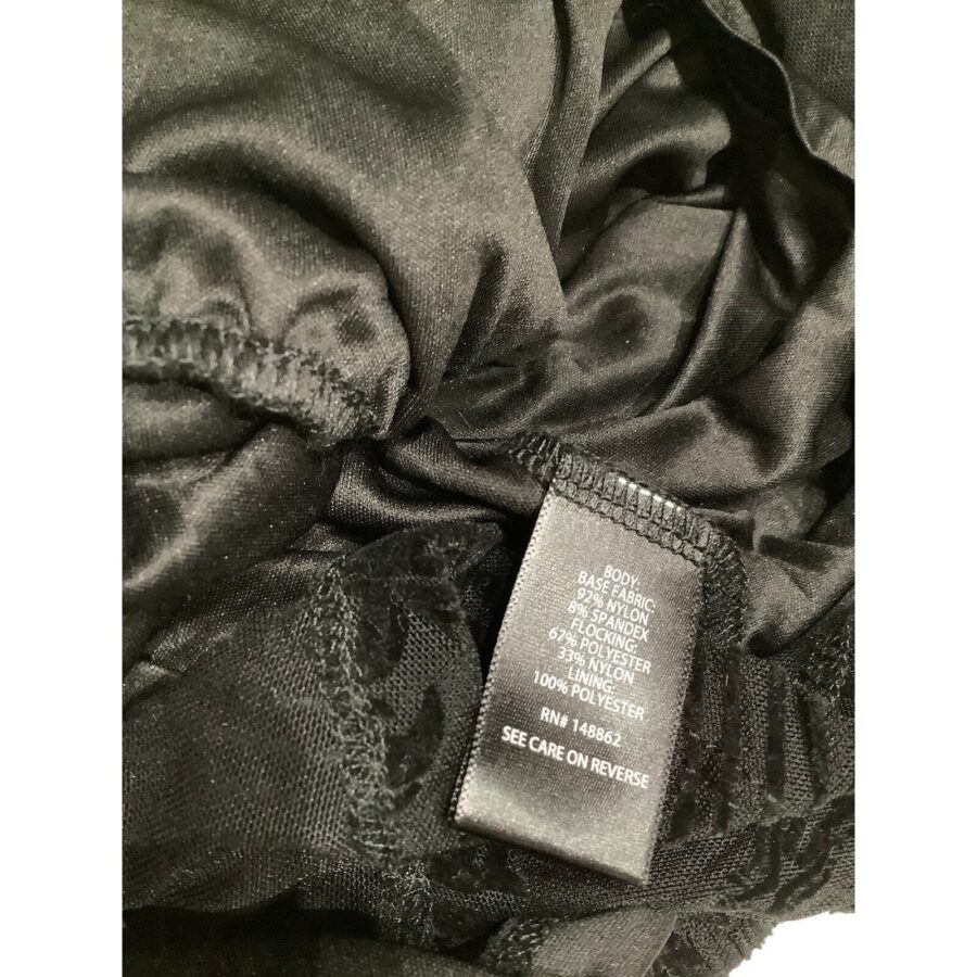 Close-up of a black fabric piece with a care label showing material composition: body is 95% rayon, 5% spandex; lace is 90% nylon, 10% spandex.