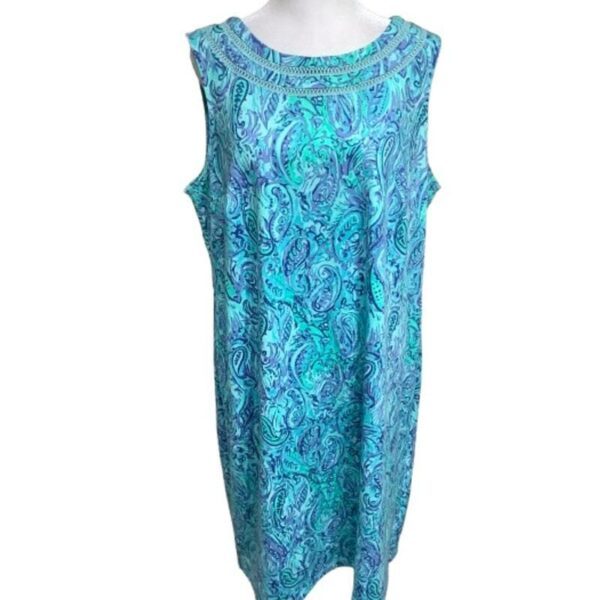 A sleeveless dress with a blue and green paisley pattern, displayed on a white mannequin. No recognizable landmarks or historical buildings visible.