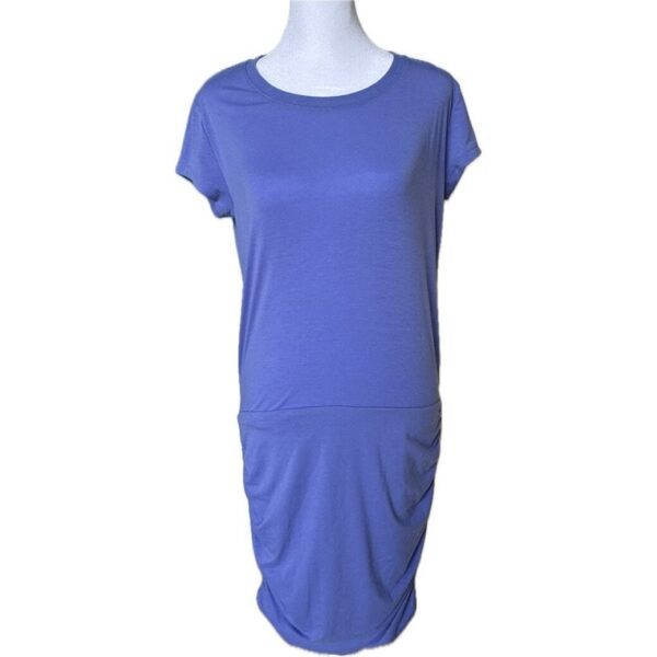 A plain, short-sleeved, blue dress is displayed on a mannequin against a white background. The dress has a simple design with a gathered waist.