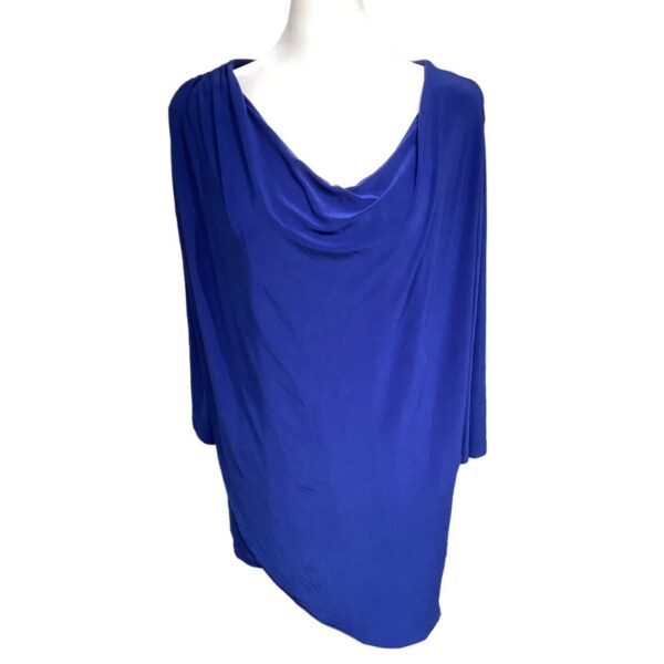 A blue, draped garment displayed on a mannequin, featuring a cowl neckline and loose fit, suitable for elegant or casual wear.