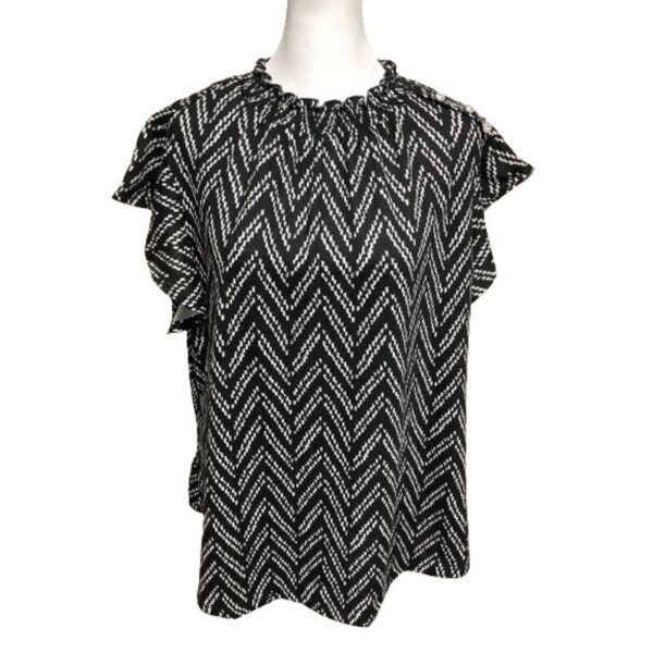 A black and white chevron-patterned, short-sleeve blouse displayed on a mannequin against a plain white background. No landmarks or historical buildings visible.