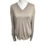 A beige V-neck sweater is displayed against a white background on a mannequin torso, exhibiting a relaxed, long-sleeved design.