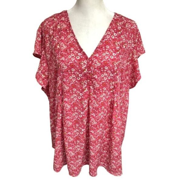 A red floral-patterned blouse is displayed on a mannequin, featuring short sleeves and a V-neckline with a loose, flowing fit.