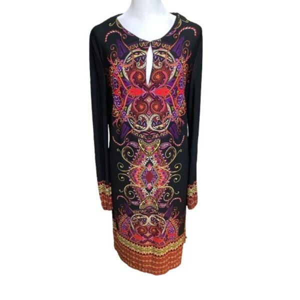 A vibrant, intricately patterned long-sleeve dress with a mix of red, purple, and gold designs displayed on a mannequin against a plain background.