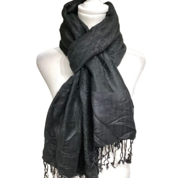 A black scarf with fringed edges is draped around a white mannequin torso, creating a sophisticated and elegant look.