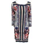 A long-sleeved, patterned dress featuring intricate designs in blue and pink floral accents. The dress has a modest neckline and a knee-length hem.