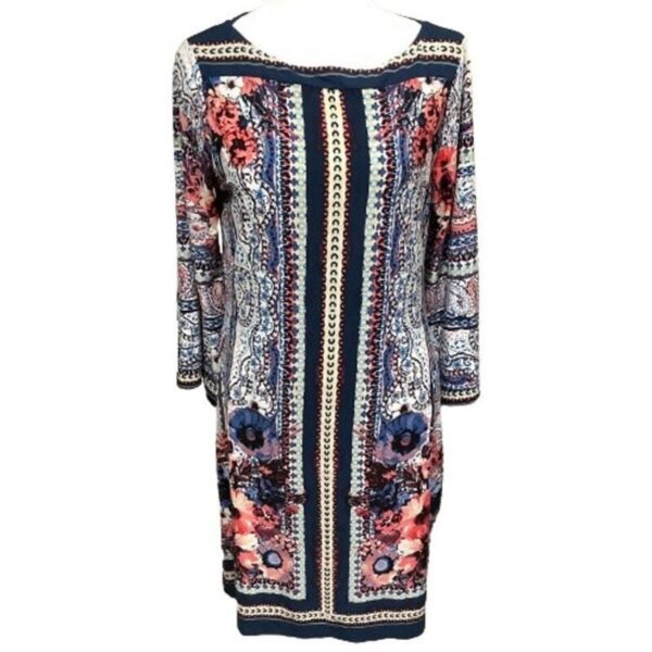 A long-sleeved, patterned dress featuring intricate designs in blue and pink floral accents. The dress has a modest neckline and a knee-length hem.