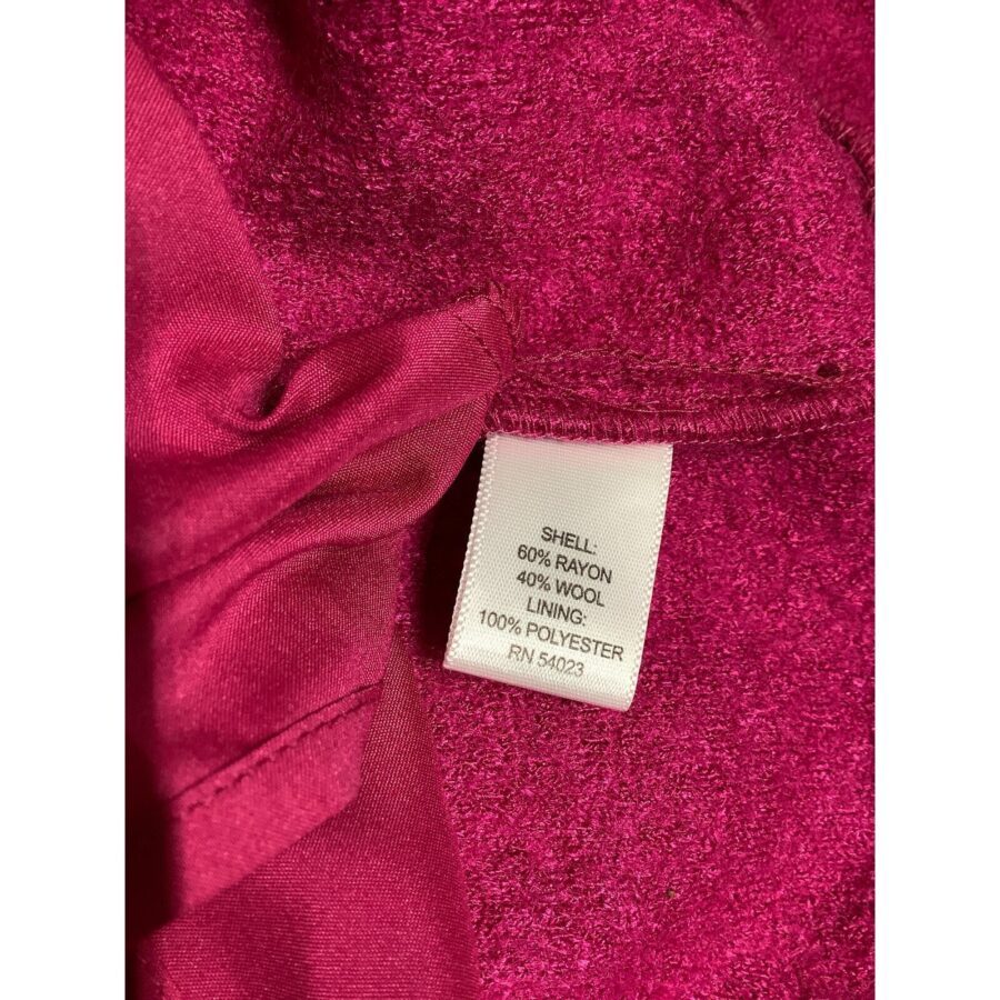 Close-up of a burgundy fabric with a white care label. The label indicates material composition: shell (60% rayon, 40% wool) and lining (100% polyester).