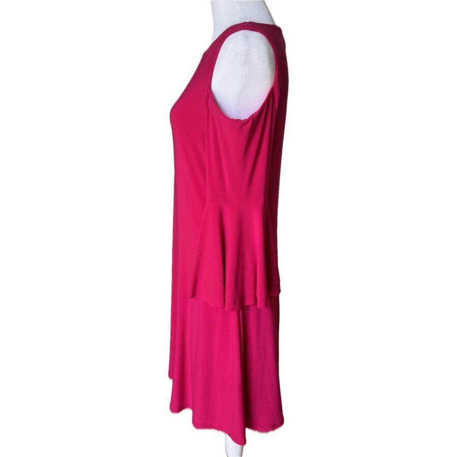 A pink sleeveless dress is displayed on a white mannequin. The dress has a layered design with a flared, knee-length hem.