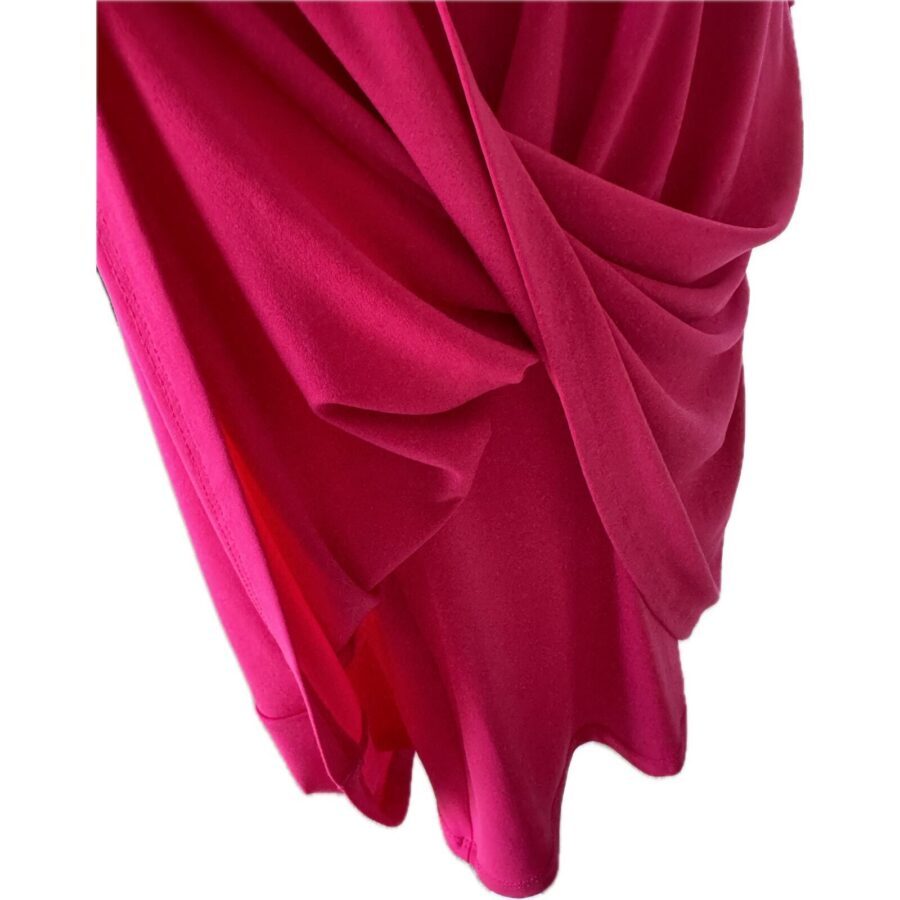 Close-up of draped, vibrant pink fabric with smooth, flowing folds. No identifiable landmarks or historical buildings are visible in this image.