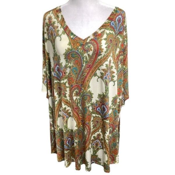 A paisley-patterned top with a V-neckline displayed on a mannequin. The intricate design features colorful, swirling patterns against a light background.