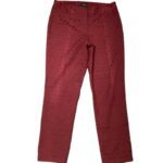 A pair of red pants with a subtle dotted pattern is laid flat against a white background. There are no landmarks or historical buildings.