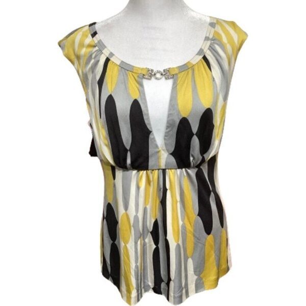 A sleeveless, patterned top with yellow, black, and gray designs, displayed on a mannequin. It has a gathered waist and decorative neckline.