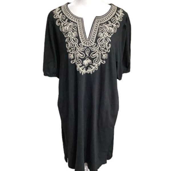 A black, intricately embroidered tunic with an ornate, patterned neckline and short sleeves, displayed against a plain white background.