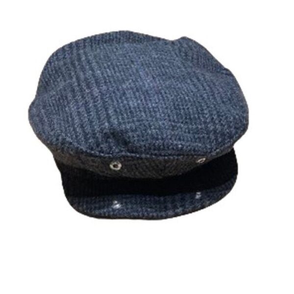 A patterned dark blue newsboy cap is displayed against a white background. The cap has a classic design with a brim and button details.