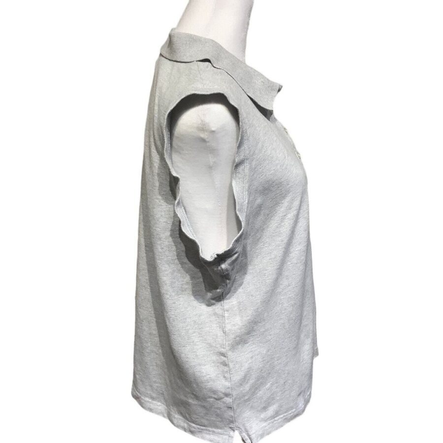 A sleeveless light gray shirt displayed on a mannequin. The shirt has a collar and is shown from a side angle against a plain white background.