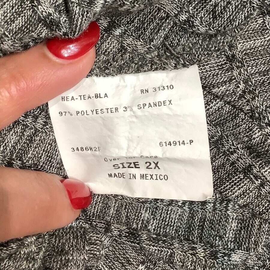 A person with red nail polish holds a gray fabric tag showing fabric composition (97% polyester, 3% spandex), size (2X), and "Made in Mexico."