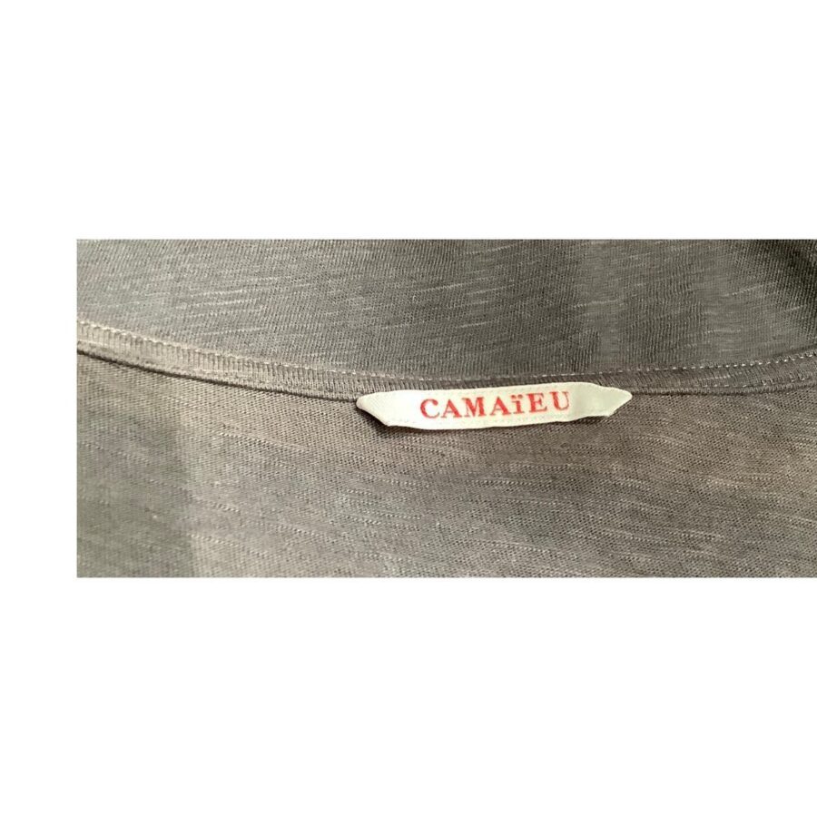 This image shows a gray fabric with a small white tag labeled "Camaieu" sewn onto it. There are no landmarks or historical buildings present.