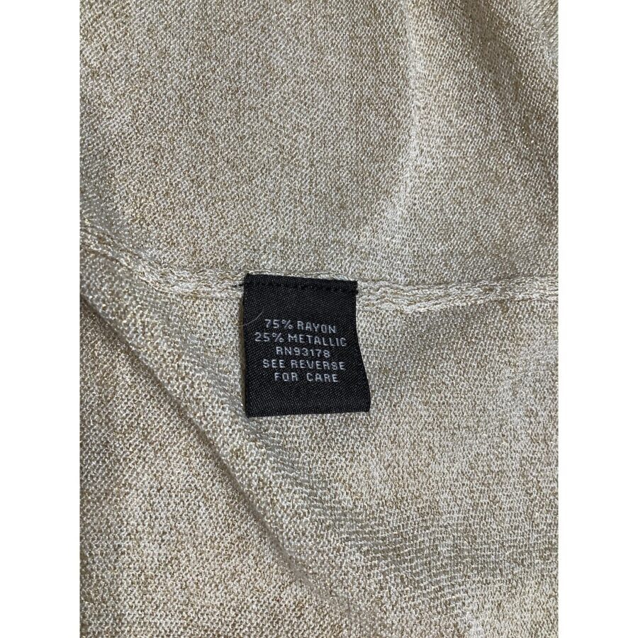 A close-up image of a clothing label showing fabric composition: 75% rayon, 25% metallic. The label advises checking the reverse side for care instructions.