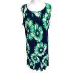 A sleeveless dress with a green and blue floral pattern on a white mannequin. There are no recognizable landmarks or historical buildings in the image.