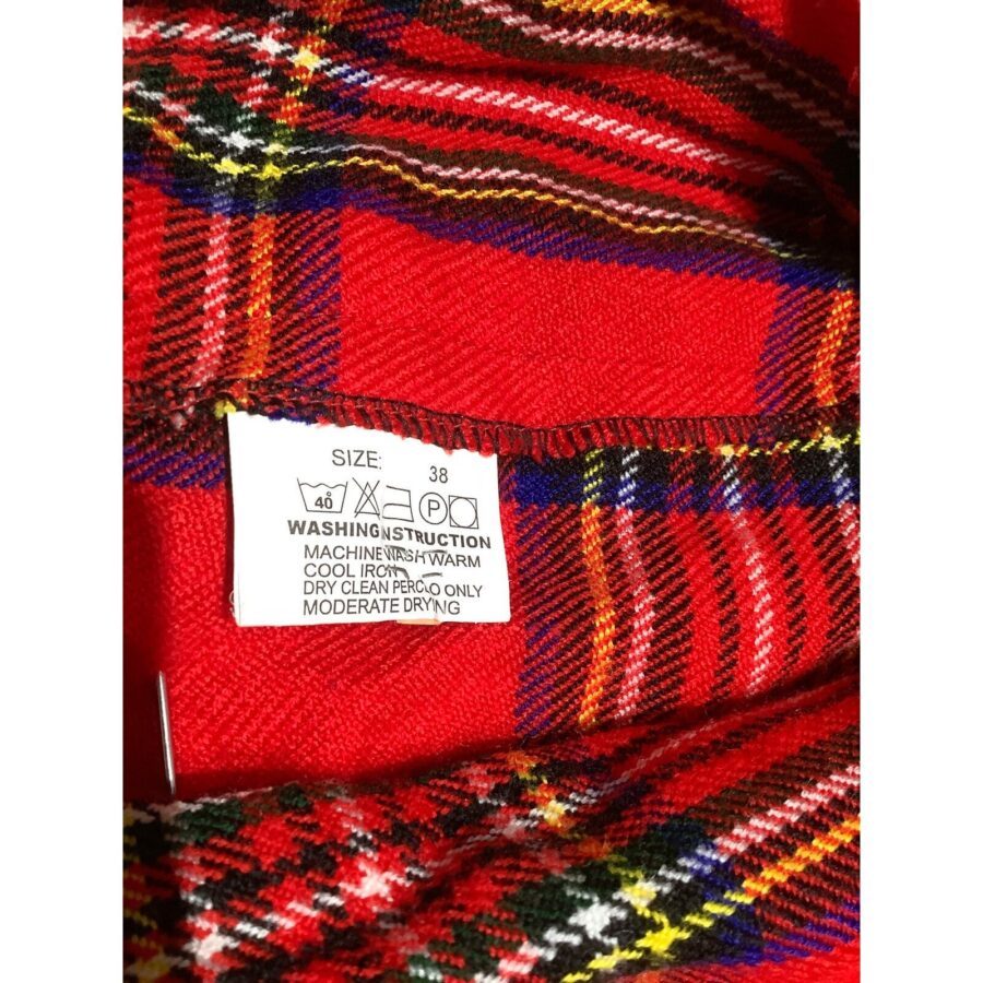 Image shows a close-up of a red plaid piece of clothing with a size and washing instruction label. Size is 38 with care instructions.