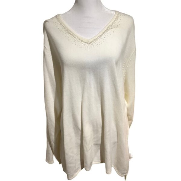 A beige, long-sleeved V-neck sweater is displayed on a mannequin. The sweater features subtle decorative details along the neckline.