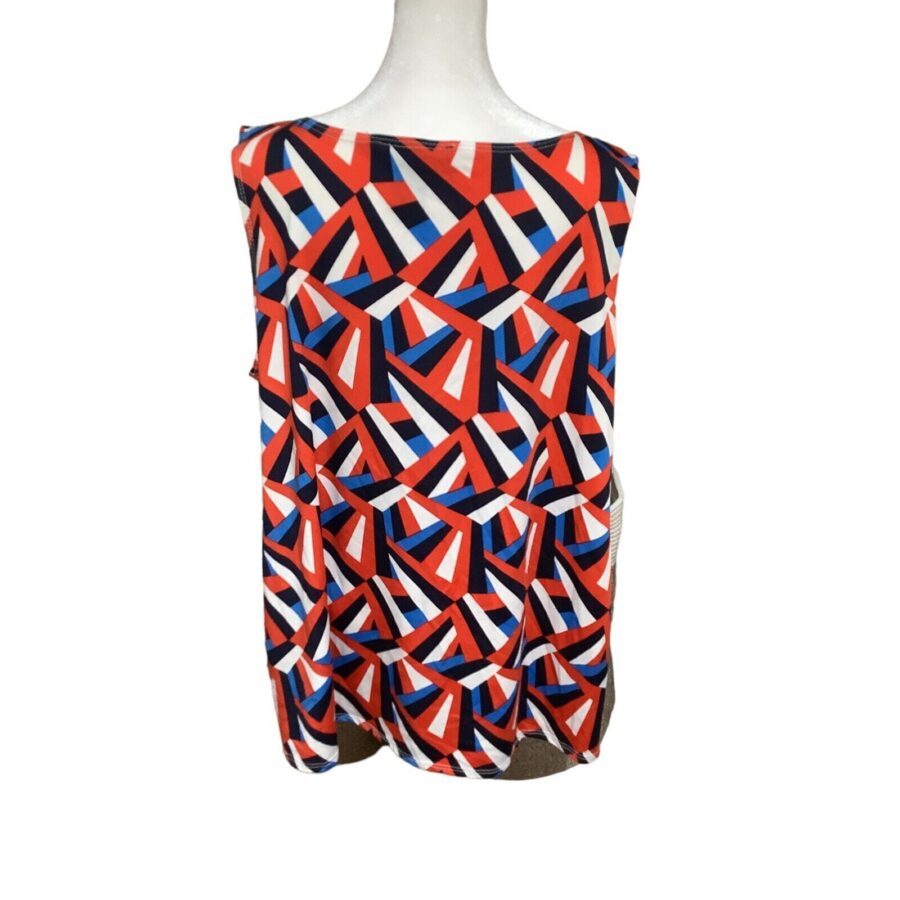 A brightly patterned sleeveless top featuring red, white, and blue geometric shapes is displayed on a white mannequin torso.