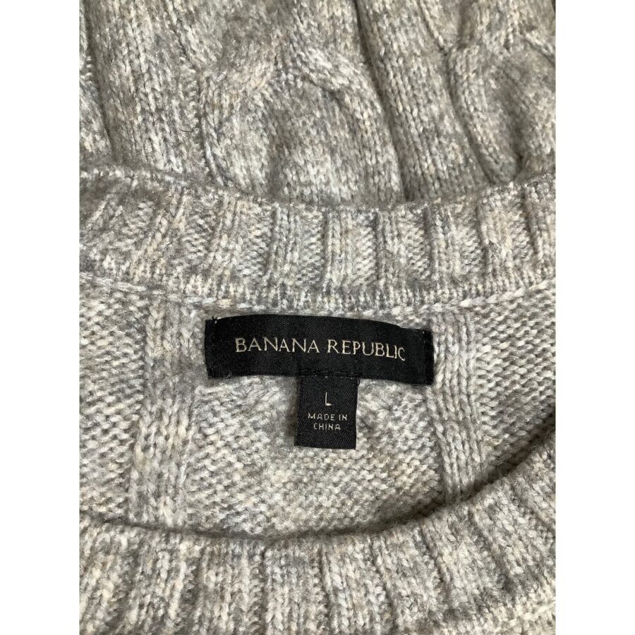 A close-up of a gray knit sweater's collar, displaying a "Banana Republic" label and a "Made in China" tag indicating size L.