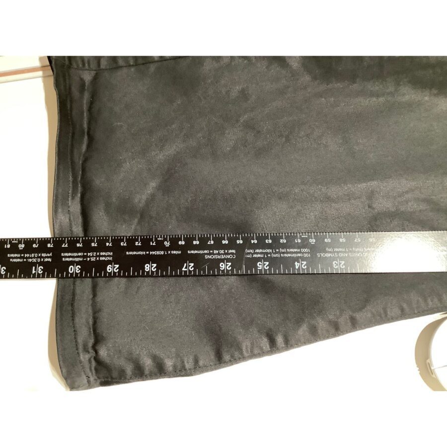 A black fabric with a tailored edge, measured using a black ruler extending across. The measurement reads approximately 22 inches, placed on a white surface.