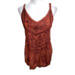 A reddish-orange, intricately embroidered top displayed on a mannequin, featuring floral and geometric patterns with a sleeveless, V-neck design.