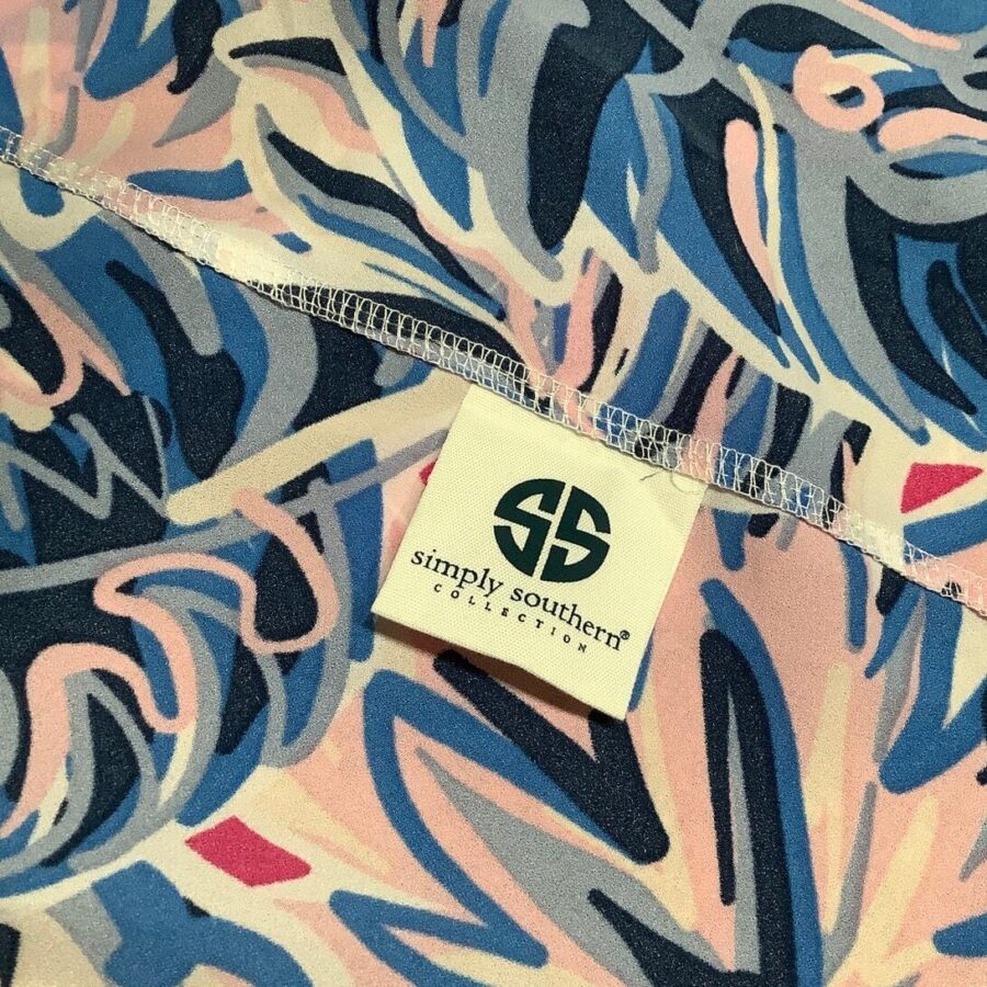 A colorful fabric with abstract patterns and a "Simply Southern Collection" label featuring the brand's logo in shades of blue, pink, and white.